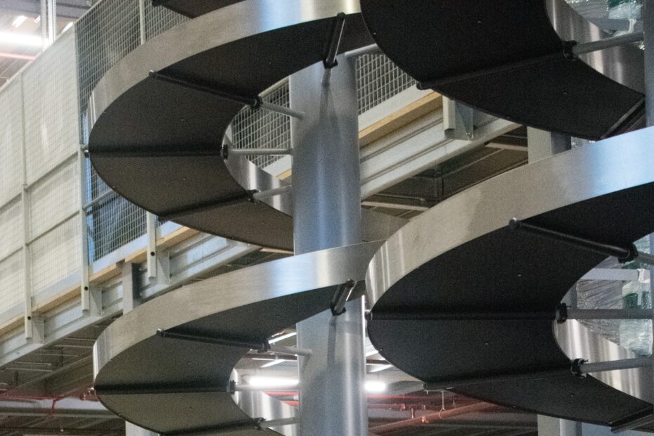Close up image of two spiral conveyors next to each-other.